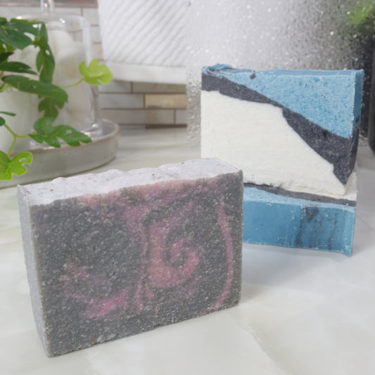 A selection of salt soaps in various colours are on a bathroom countertop