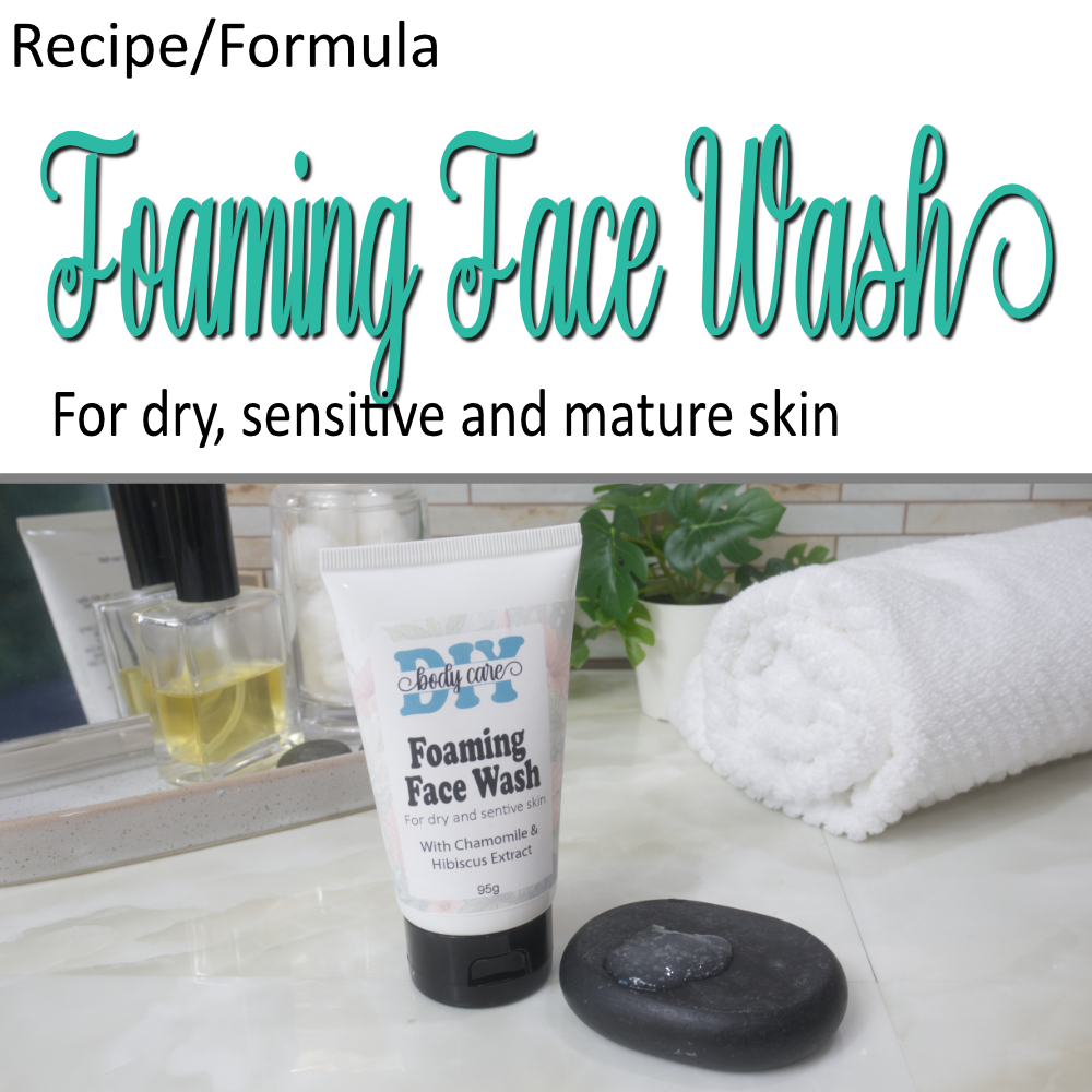 A cover photo indicating this is for a Recipe/Formula.  The top half of the image has a white background with cursive teal text announcing this is a Foaming Hand Wash.  In the lower half is a photo showing a white squeze tube with black flip top cap standing on a bathroom countertop with a towel and perfume. Next to the tube is a flat black rock that has a small amount of translucent gel sitting on it.