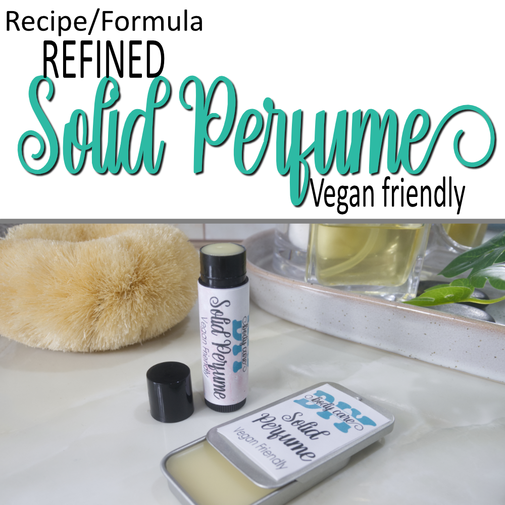 A cover photo that has two layers.  The top half has a white background with decorative teal text announcing a Refined Solid Perfume, Vegan friendly formula.  Below is a photo of some solid perfume sitting on a bathroom bench.  One is presented in a rectangular silver tin with a sliding lid while the other is a black tube like lip balm.  The lids are open on both revealing white balm inside.