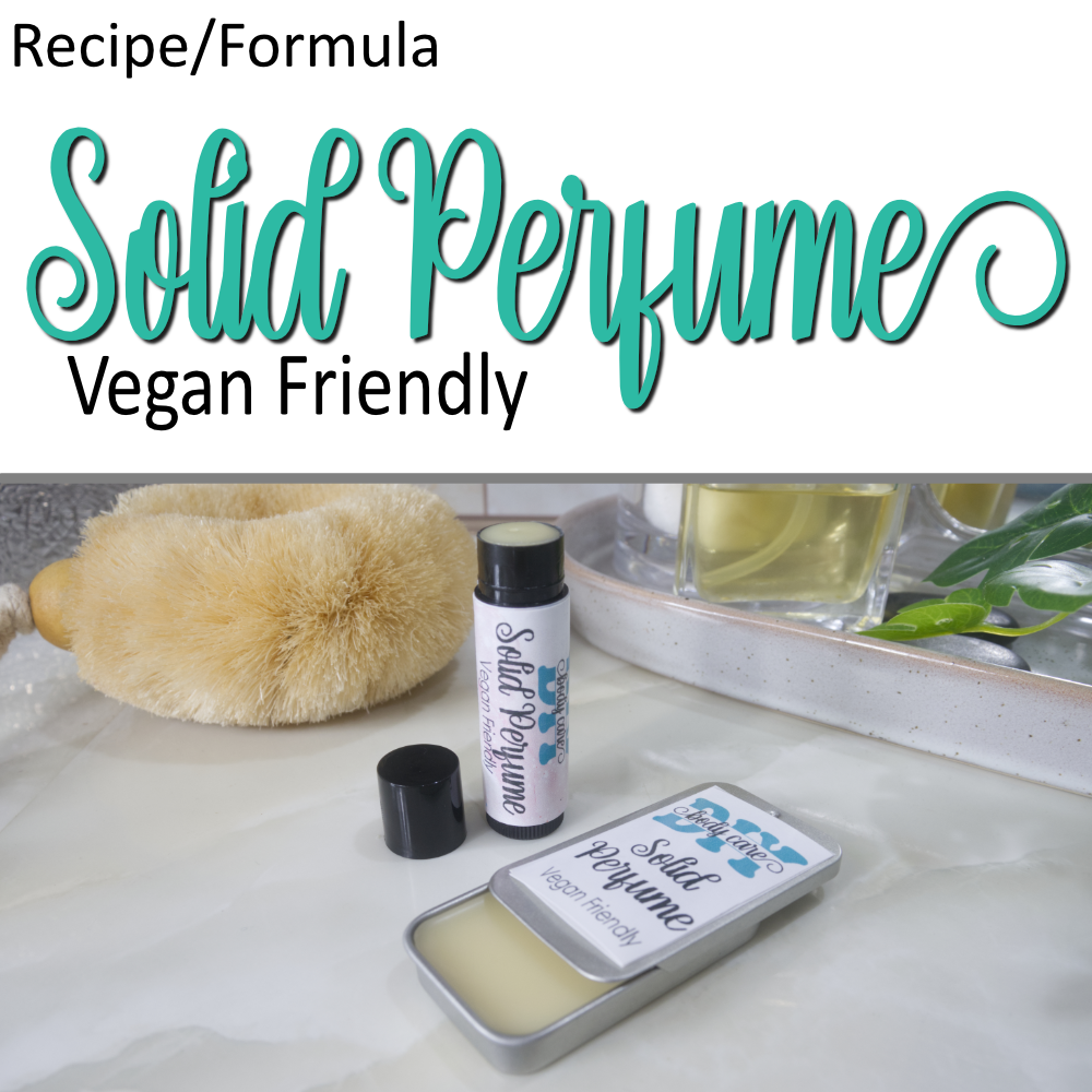 A cover photo that has two layers.  The top half has a white background with decorative teal text announcing a Solid Perfume, Vegan friendly formula.  Below is a photo of some solid perfume sitting on a bathroom bench.  One is presented in a rectangular silver tin with a sliding lid while the other is a black tube like lip balm.  The lids are open on both revealing white balm inside.